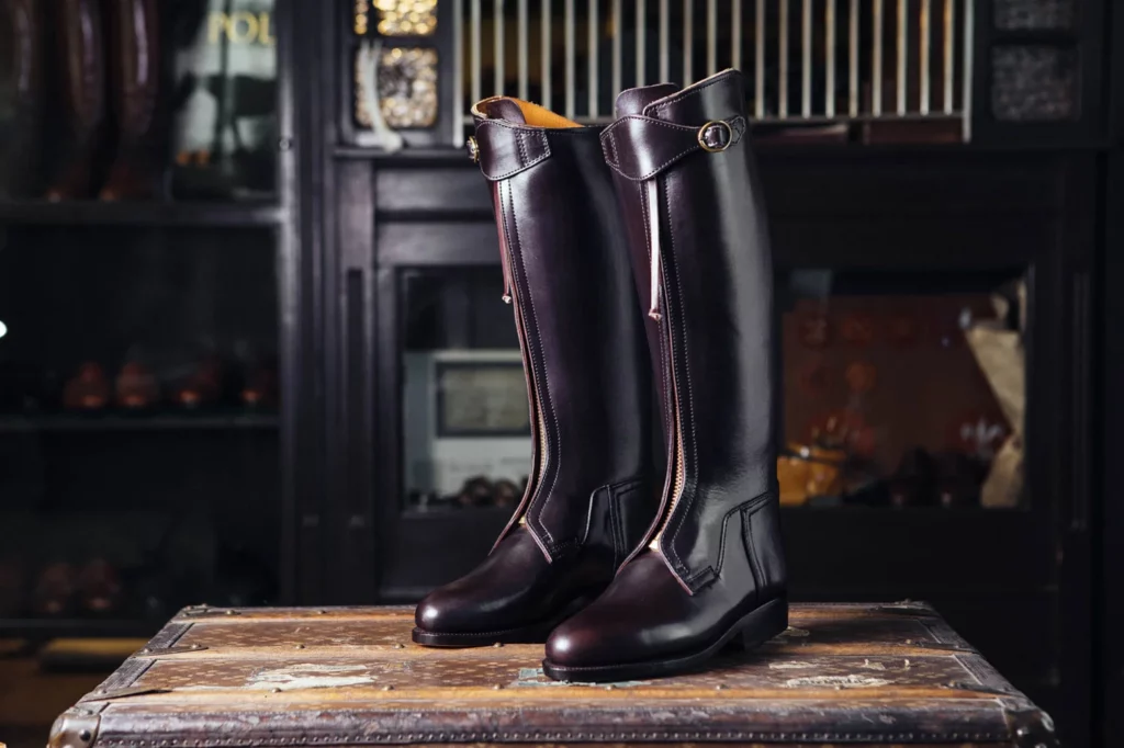 Polo boots for riders placed on a table